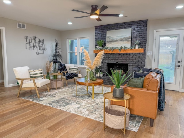 2106 Teague Rd, Houston, TX 77080 - living room with ceiling fan, light wood-style flooring, a fireplace, recessed lighting, and baseboards