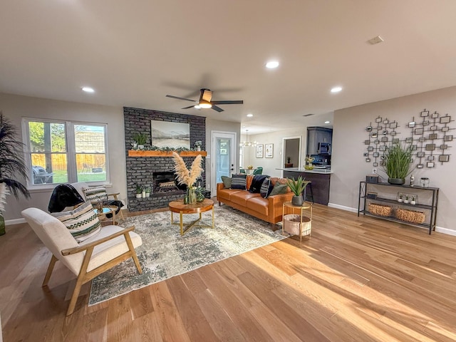 2106 Teague Rd, Houston, TX 77080 - living room featuring light wood-type flooring, a brick fireplace, a ceiling fan, baseboards, and recessed lighting