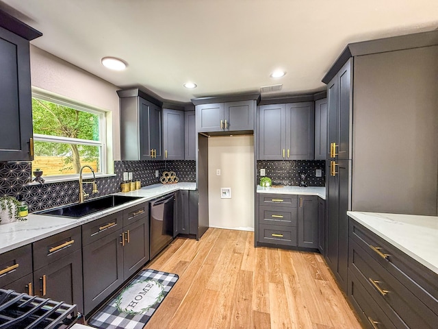 2106 Teague Rd, Houston, TX 77080 - kitchen with a sink, light wood-style floors, light stone counters, dishwasher, and tasteful backsplash