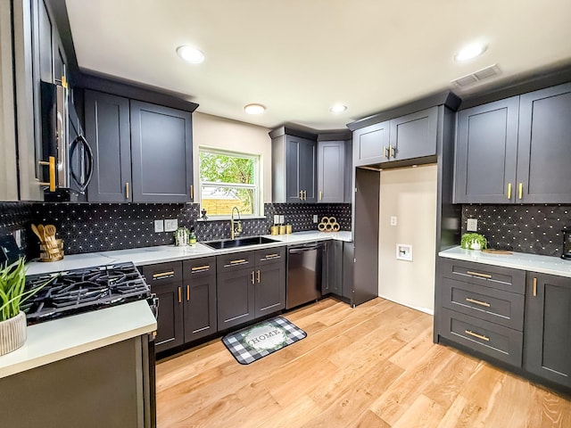 2106 Teague Rd, Houston, TX 77080 - kitchen with dishwasher, a sink, decorative backsplash, light wood-type flooring, and recessed lighting