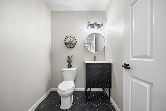 2106 Teague Rd, Houston, TX 77080 - bathroom with vanity, toilet, tile patterned floors, and baseboards