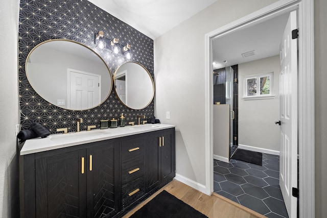 2106 Teague Rd, Houston, TX 77080 - bathroom featuring double vanity, a stall shower, and wood finished floors