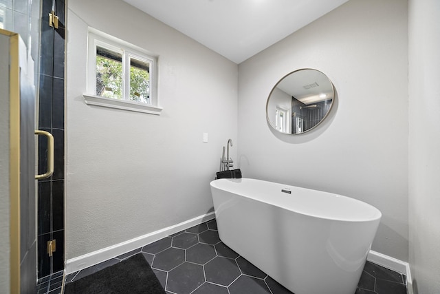2106 Teague Rd, Houston, TX 77080 - bathroom featuring a soaking tub, baseboards, and tile patterned floors