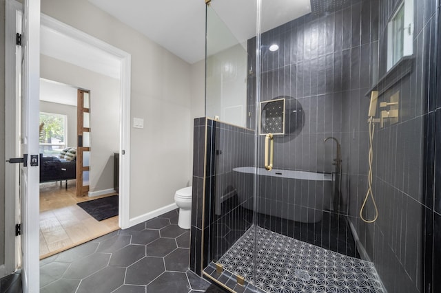 2106 Teague Rd, Houston, TX 77080 - bathroom with a shower stall, toilet, tile patterned flooring, and ensuite bathroom