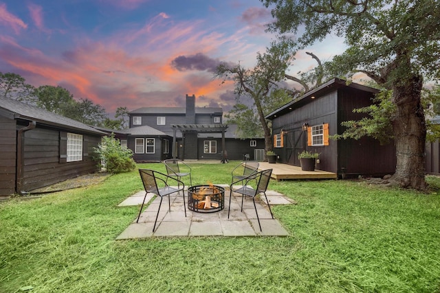 2106 Teague Rd, Houston, TX 77080 - view of grassy yard featuring a fire pit, a pergola, a deck, a patio, and an outdoor structure