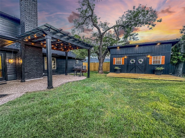 2106 Teague Rd, Houston, TX 77080 - yard at dusk with a pergola, an outbuilding, and a patio