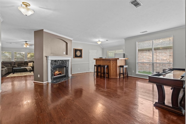 3238 Bodine Dr, Pearland, TX 77584 - living room with a ceiling fan, dark wood finished floors, a high end fireplace, crown molding, and baseboards