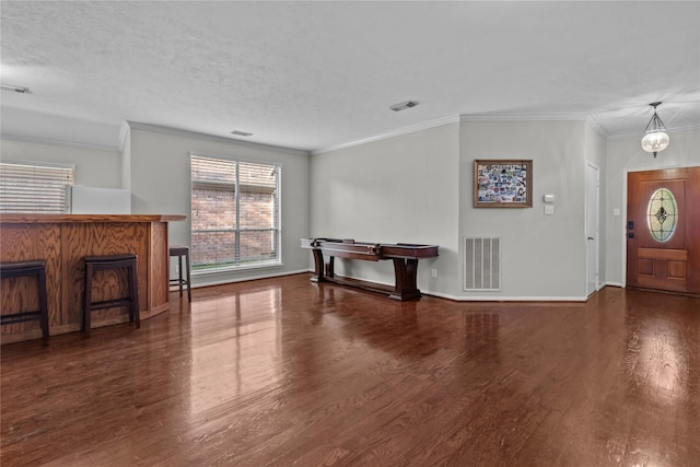 3238 Bodine Dr, Pearland, TX 77584 - unfurnished living room with wood finished floors, baseboards, crown molding, and a textured ceiling