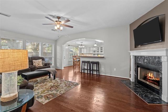 3238 Bodine Dr, Pearland, TX 77584 - living room featuring arched walkways, wood finished floors, a premium fireplace, a chandelier, and ceiling fan