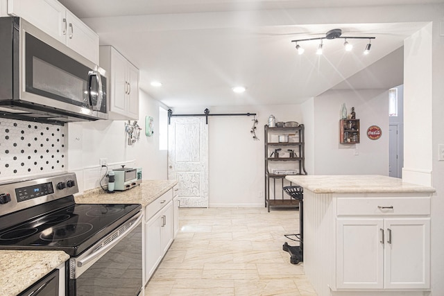 2778 Fm 2610th Rd, Cleveland, TX 77327 - kitchen featuring appliances with stainless steel finishes, white cabinets, plenty of natural light, decorative backsplash, and recessed lighting