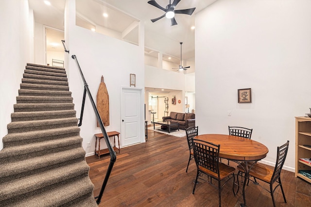 2778 Fm 2610th Rd, Cleveland, TX 77327 - dining area featuring a ceiling fan, stairway, dark wood finished floors, baseboards, and a towering ceiling