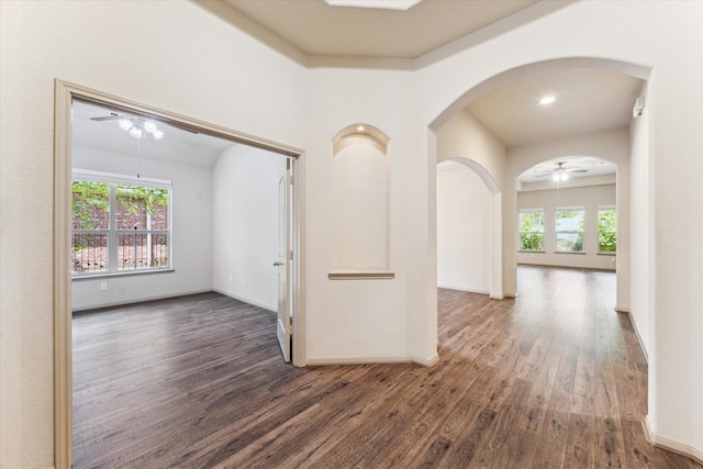 107 N Greenprint Cir, Tomball, TX 77375 - unfurnished room with a ceiling fan, wood finished floors, arched walkways, and baseboards