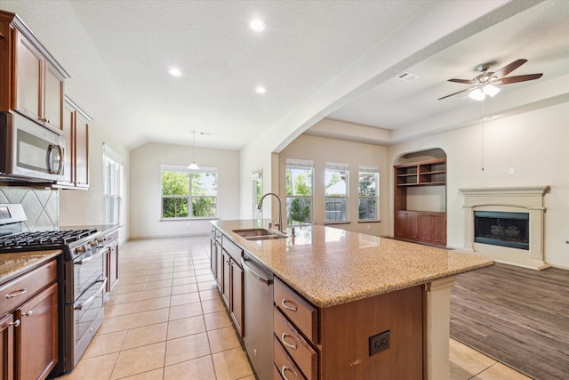 107 N Greenprint Cir, Tomball, TX 77375 - kitchen featuring stainless steel appliances, a sink, open floor plan, recessed lighting, and light tile patterned flooring
