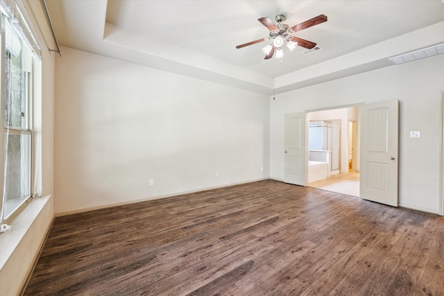 107 N Greenprint Cir, Tomball, TX 77375 - unfurnished room with wood finished floors, a raised ceiling, a ceiling fan, and baseboards