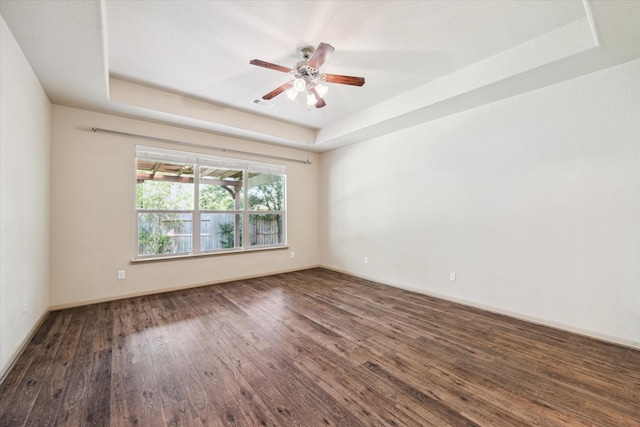 107 N Greenprint Cir, Tomball, TX 77375 - unfurnished room featuring a raised ceiling, wood finished floors, ceiling fan, and baseboards