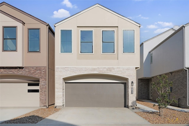 2933 El Fenice Ln, Houston, TX 77057 - view of front of home featuring stone siding, a garage, and concrete driveway