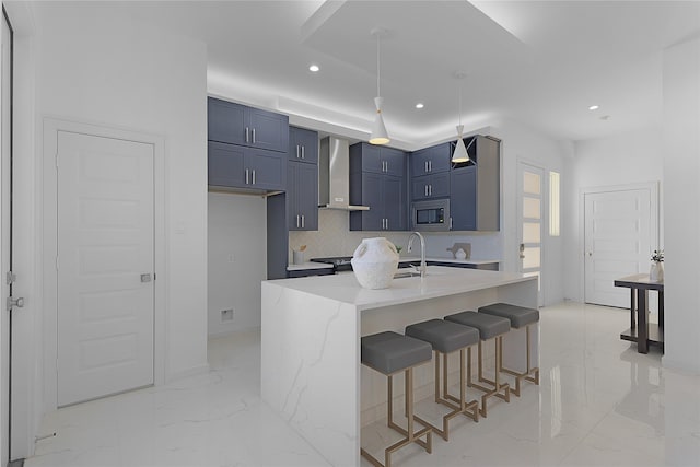 2933 El Fenice Ln, Houston, TX 77057 - kitchen featuring stainless steel microwave, wall chimney range hood, light marble finish floors, blue cabinetry, and a sink
