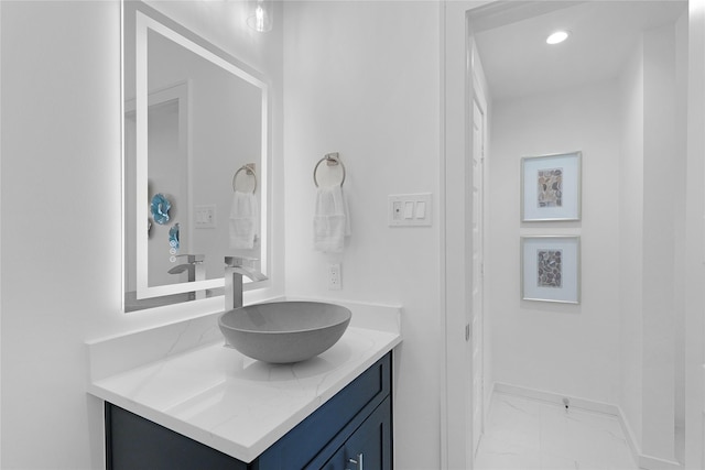 2933 El Fenice Ln, Houston, TX 77057 - bathroom with marble finish flooring, vanity, baseboards, and recessed lighting