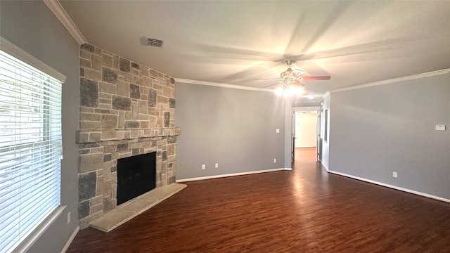 10208 Forest Spring Ln, Pearland, TX 77584 - unfurnished living room featuring ceiling fan, dark wood-style flooring, crown molding, a stone fireplace, and baseboards