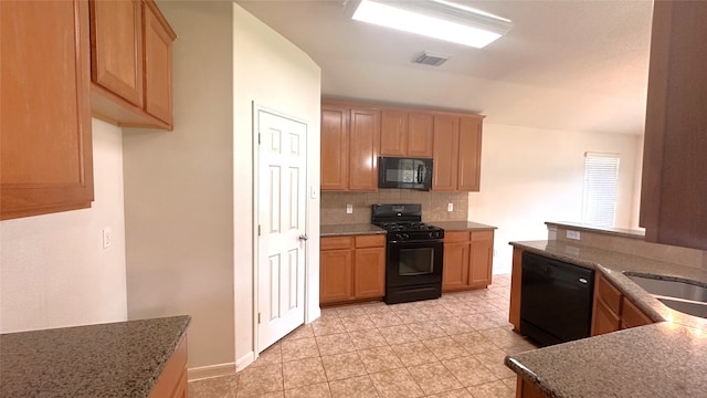 10208 Forest Spring Ln, Pearland, TX 77584 - kitchen with black appliances, decorative backsplash, stone counters, light tile patterned floors, and a sink