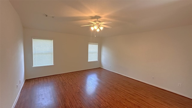 10208 Forest Spring Ln, Pearland, TX 77584 - unfurnished room featuring plenty of natural light, ceiling fan, baseboards, and wood finished floors