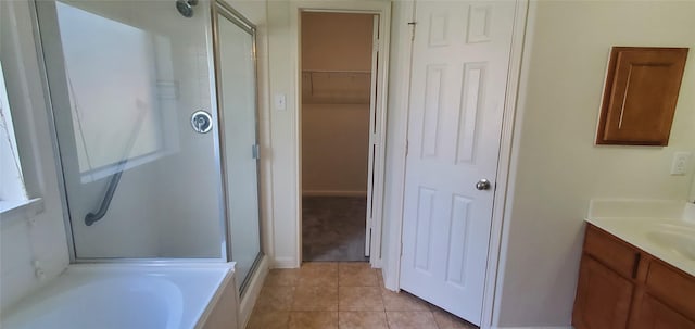 10208 Forest Spring Ln, Pearland, TX 77584 - full bath featuring a stall shower, vanity, tile patterned flooring, a bath, and a walk in closet