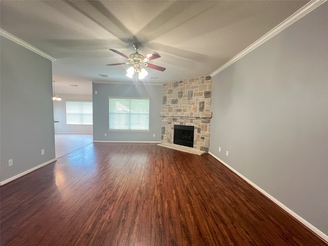 10208 Forest Spring Ln, Pearland, TX 77584 - unfurnished living room featuring ornamental molding, ceiling fan, a stone fireplace, wood finished floors, and baseboards