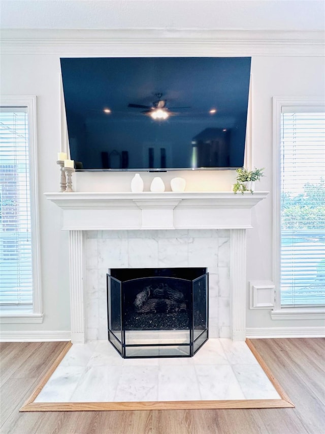 7210 Blenheim Palace Ln, Houston, TX 77095 - detailed view of a tile fireplace, wood finished floors, baseboards, and ornamental molding
