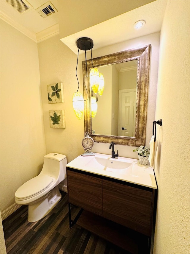 7210 Blenheim Palace Ln, Houston, TX 77095 - bathroom with ornamental molding, toilet, vanity, wood finished floors, and baseboards