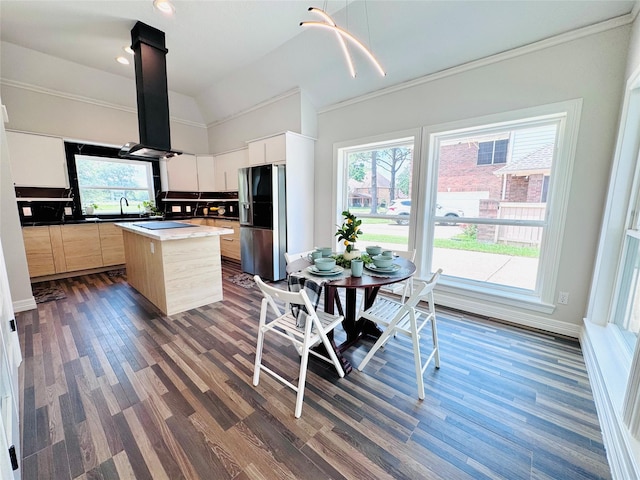 7210 Blenheim Palace Ln, Houston, TX 77095 - kitchen with stainless steel fridge, dark wood-style floors, a kitchen island, island exhaust hood, and ornamental molding