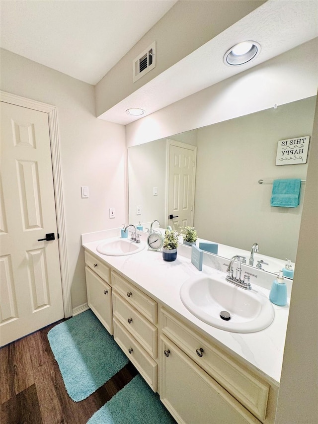 7210 Blenheim Palace Ln, Houston, TX 77095 - bathroom featuring double vanity, wood finished floors, recessed lighting, and baseboards