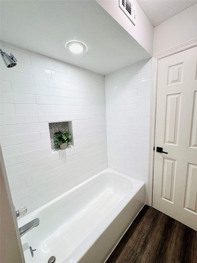 7210 Blenheim Palace Ln, Houston, TX 77095 - full bathroom with wood finished floors, shower / washtub combination, and a textured ceiling