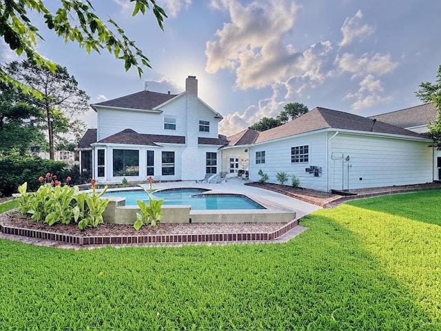 7210 Blenheim Palace Ln, Houston, TX 77095 - back of house featuring a lawn, an outdoor pool, a chimney, and a patio area