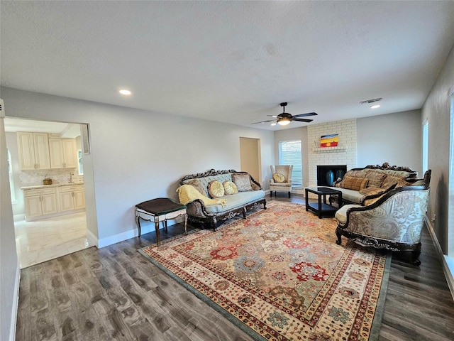 15358 Mcconn St, Houston, TX 77598 - living area featuring ceiling fan, wood finished floors, a fireplace, baseboards, and recessed lighting
