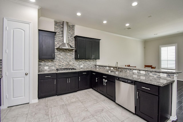 2213 Bellefontaine St, Houston, TX 77030 - kitchen with appliances with stainless steel finishes, wall chimney range hood, a sink, crown molding, and a peninsula