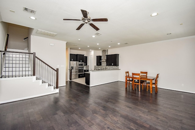 2213 Bellefontaine St, Houston, TX 77030 - living room with ceiling fan, recessed lighting, ornamental molding, dark wood finished floors, and stairway