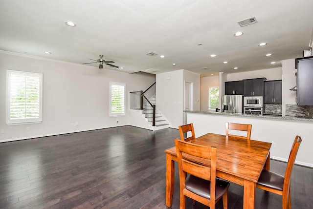 2213 Bellefontaine St, Houston, TX 77030 - dining room with recessed lighting, dark wood-type flooring, a ceiling fan, stairway, and crown molding