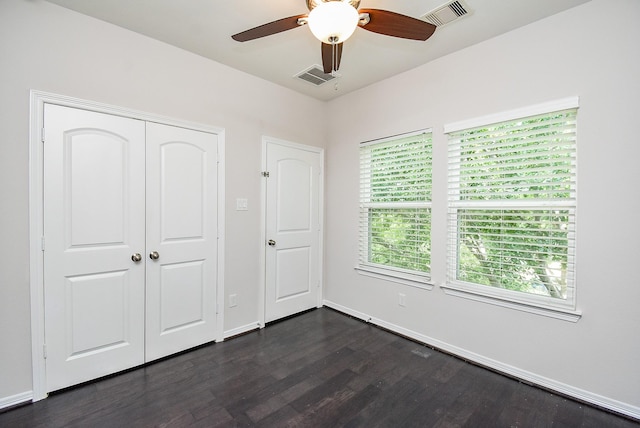 2213 Bellefontaine St, Houston, TX 77030 - unfurnished bedroom with dark wood-style flooring, a closet, a ceiling fan, and baseboards