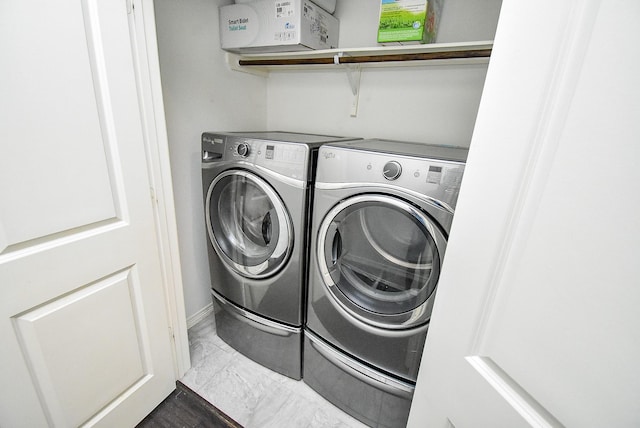 2213 Bellefontaine St, Houston, TX 77030 - laundry area featuring independent washer and dryer and marble look tiles