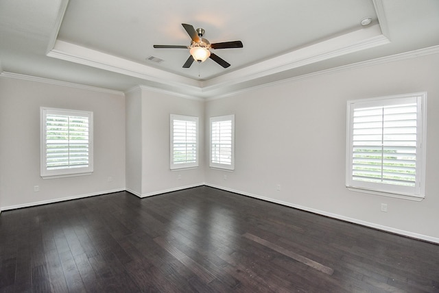 2213 Bellefontaine St, Houston, TX 77030 - empty room featuring a raised ceiling, ceiling fan, healthy amount of natural light, dark wood finished floors, and crown molding