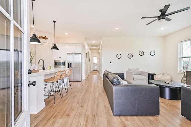 2515 103rd St, Galveston, TX 77554 - living area with light wood-type flooring, ceiling fan, and recessed lighting