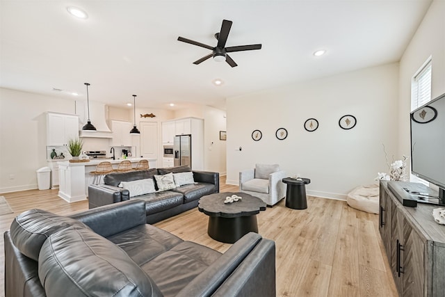 2515 103rd St, Galveston, TX 77554 - living room featuring ceiling fan, light wood finished floors, baseboards, and recessed lighting