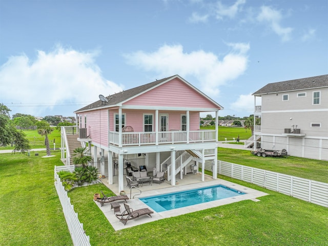 2515 103rd St, Galveston, TX 77554 - rear view of property featuring stairway, an outdoor hangout area, and a patio area