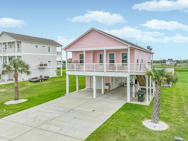 2515 103rd St, Galveston, TX 77554 - view of front of home featuring a garage, driveway, stairs, a front yard, and a carport