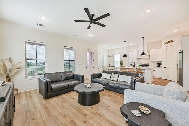 2515 103rd St, Galveston, TX 77554 - living room featuring light wood-style flooring, ceiling fan, recessed lighting, and baseboards