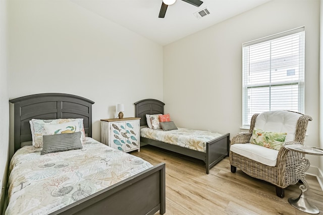 2515 103rd St, Galveston, TX 77554 - bedroom featuring multiple windows, light wood finished floors, and ceiling fan