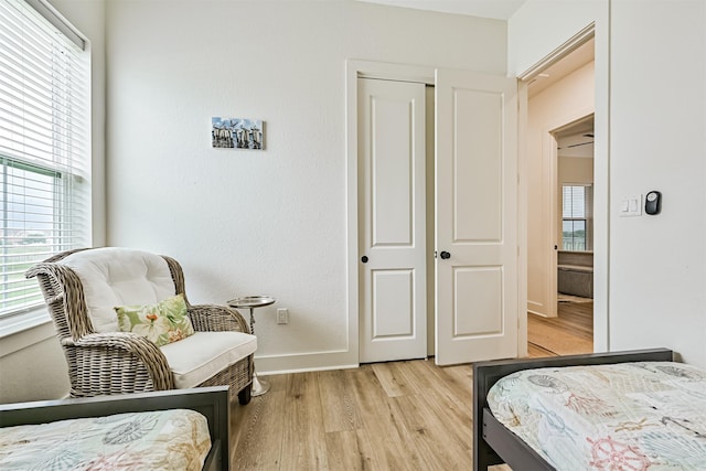 2515 103rd St, Galveston, TX 77554 - bedroom with light wood-style floors, multiple windows, and baseboards