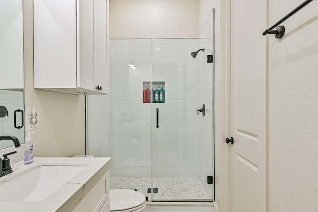 2515 103rd St, Galveston, TX 77554 - full bathroom with vanity, a stall shower, and toilet