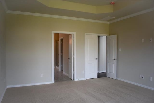 811 River Delta Ln, Rosenberg, TX 77469 - unfurnished bedroom featuring carpet flooring, crown molding, a tray ceiling, and a closet