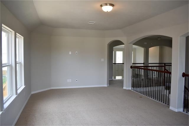 811 River Delta Ln, Rosenberg, TX 77469 - carpeted empty room featuring lofted ceiling and arched walkways